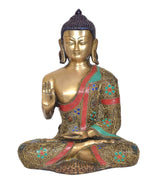 Front view meditating Buddha idol with raised palm hand, brass finish and colorful inlay