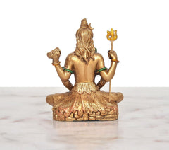 Rear view of seated four-armed Shiva idol, gold resin with green arm bands