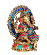 Brass Ganesha statue idol on lotus, raised hands and colorful beadwork, angled view
