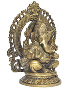 Brass Ganesha statue angled view, one hand raised, detailed torso ornaments and halo