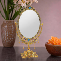 Oval tabletop mirror with gold-plated ornate frame, blue jewel accents, hanging bead chains