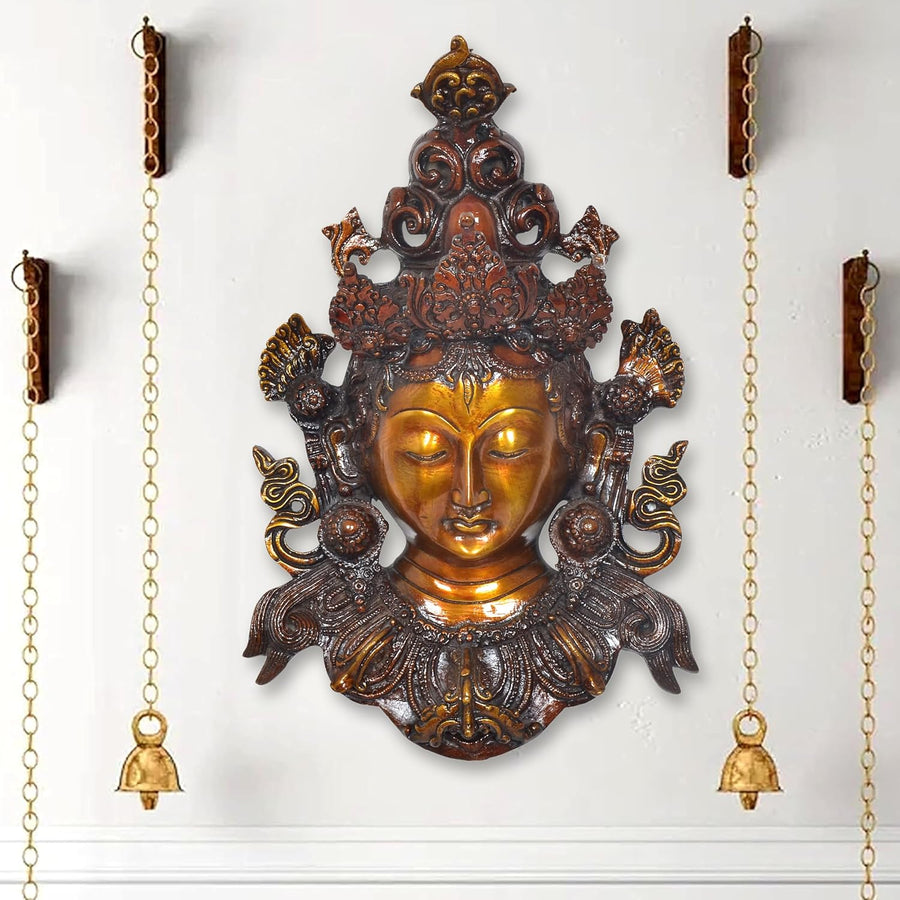 Tara wall hanging mask statue with gold face, ornate bronze detailing, hanging chains