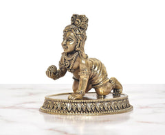 Bronze Bal Gopal Krishna idol, side pose with raised right hand and patterned base