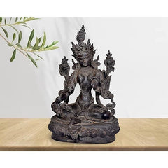 Tara Devi statue, seated goddess with multiple arms, dark resin finish on pedestal