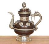 Ornate Himalayan brass teapot, rounded body with embossed panels and curved spout