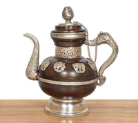 Ornate Himalayan brass teapot, rounded body with embossed panels and curved spout