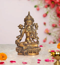 Tara Devi brass statue, seated Green Tara with ornate crown and holding bird