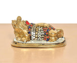 Brass Ganesha relaxing statue, gold-toned figure with multicolor gem-like patterns
