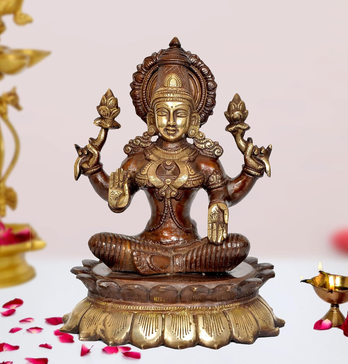 Brass Lakshmi idol, seated with four raised arms on lotus pedestal