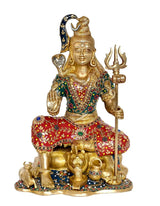 Seated brass Shiva sculpture with trident, red and green embroidered robe with beads