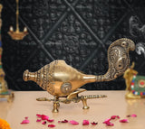 Brass shankh conch with ornate stand, rounded body with carved details and birdlike head