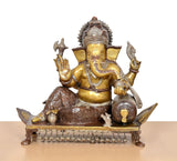 Brass Ganesha idol seated on pedestal with raised hands and detailed ornaments