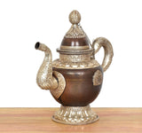 Traditional Himalayan brass teapot with finial lid, embossed band, and decorative spout detail