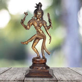 Brass Ardhanarishwar standing figurine with trident-like hand signs, dark base, gold finish