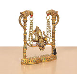 Ornate brass Ganesha swing statue with two tall posts connected by chains
