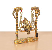 Ornate brass Ganesha swing statue with two tall posts connected by chains