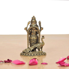 Brass Kartikeya figurine with peacock standing on patterned round pedestal
