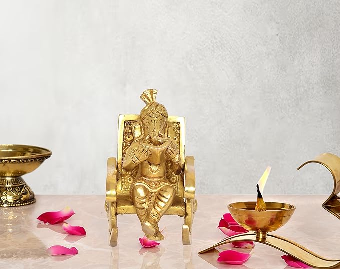 Golden brass Ganesha statue: seated on chair, reading book, 5 inch height