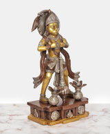 Brass Hanuman statue angled view with curved halo, star-like ornaments, and decorated base