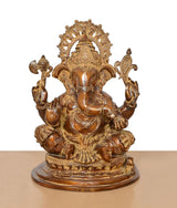 Brass Ganesha statue, brown, front view with halo arch and four arms