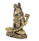 Side view brass Lord Shiva idol with trident and drum-like items, 3 inch