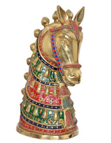 Brass horse head decor with red and blue trim, three-quarter angle