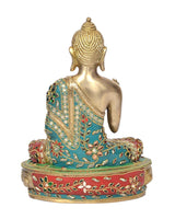 Seated brass Buddha idol from rear view, gold head and torso, turquoise and red patterned base