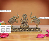 Bronze Lakshmi statue seated between elephants; 3.5 in height, ornate patterned base.