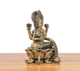 Brass Lakshmi idol side angle, lotus petals and detailed pedestal base ornament