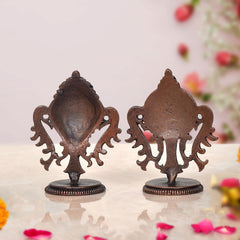 Copper Sanghu and Chakram deity figurines, reverse view with decorative filigree at handles