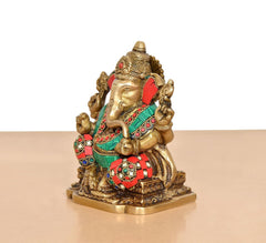 Brass Ganesh murti in profile, gold face with red and green jeweled adornments