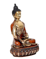 Side view Buddha statue, brass face and orange robe with carved lotus base
