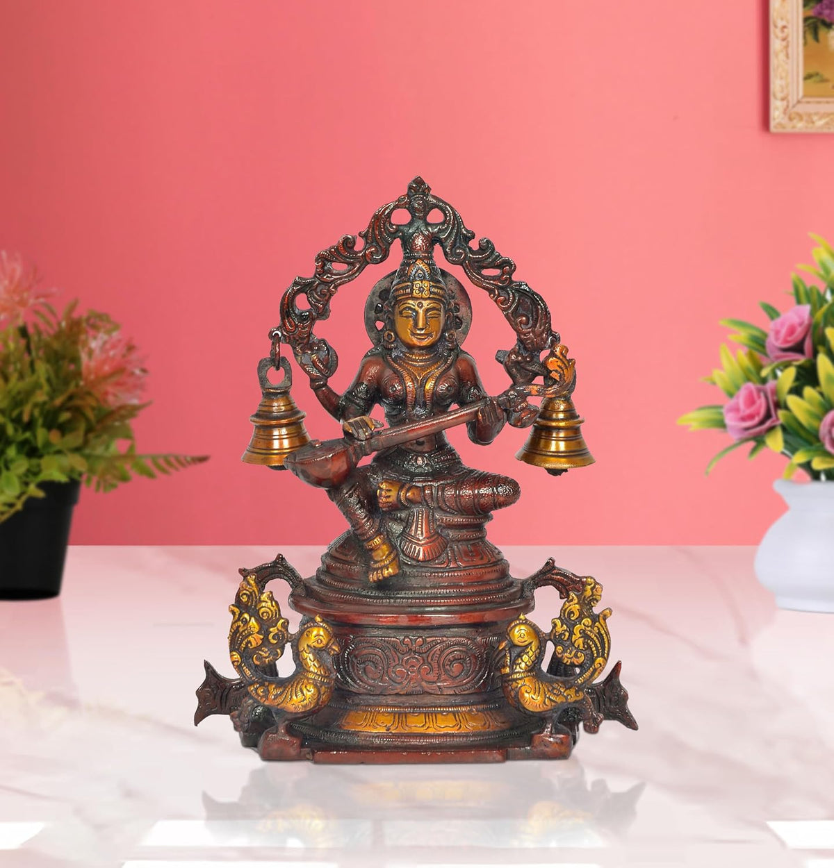 Brass Saraswati statue sitting on swan, playing veena with two bell pots