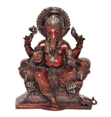 Seated Lord Ganesha brass idol with ornate crown and four arms, maroon-bronze patina