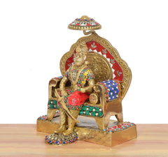 Side view brass Agrasen idol with red arch, blue detailing, decorated elephant seat