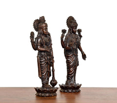 Rear side view of brass Lakshmi and Vishnu statues, lotus pedestal at bottom