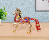 Brass running horse statue with red and blue patterned saddle, rearing pose