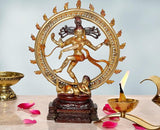 Shiva Nataraj brass idol with ornate circular halo, dancing pose on dark base