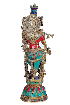 Brass Radha Krishna sculpture, side view of golden figure wearing red and teal outfit