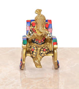 Brass Ganesha statue seated on chair, reading pose, multicolor backrest panels