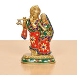 Radha-Krishna brass idol from front, red dress with floral accents, green drape, blue beadwork