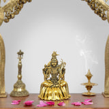 Golden seated goddess statue with raised hand and ornate crown, Tripura Sundari