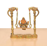 Ganesha swing statue rear view with decorated base and chain-holding posts