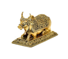 Side view gold Nandi cow idol with detailed patterned body