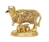 Golden brass cow statue with calf and small pots, ornate decorative detailing
