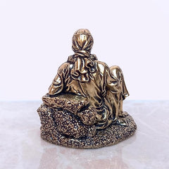 Shirdi Sai Baba brass statue, rear three-quarter view with raised head and textured base