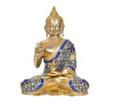 Front view brass Buddha figurine, Abhaya mudra hand raised, blue robe with gold trim