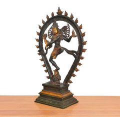 Brass Lord Shiva Natraj dancing idol, side view with detailed circular arch