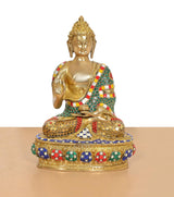 Brass Buddha idol seated in Abhaya Mudra, detailed jeweled base and robe, gold tone