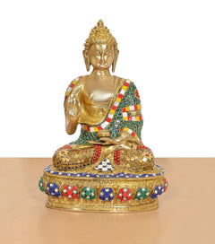 Brass Buddha idol seated in Abhaya Mudra, detailed jeweled base and robe, gold tone